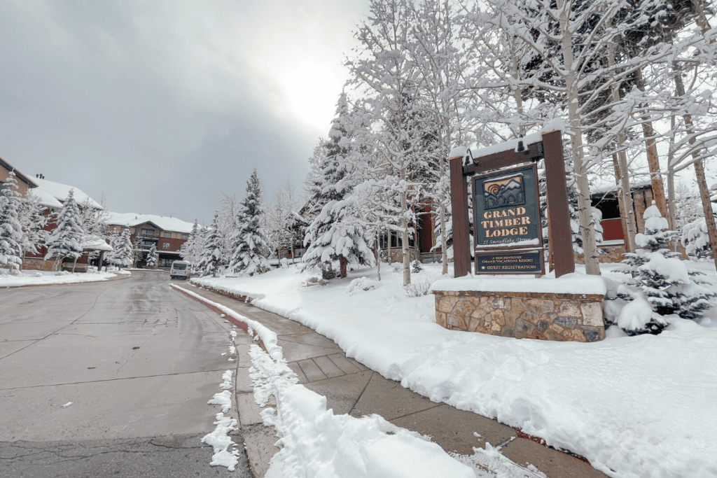 breckenridge hotels downtown sign of Grand Timber Lodge with snow