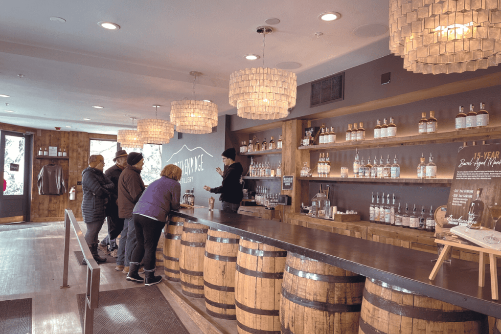 breckenridge distillery tasting room- people standing at the bar talking to the bartender.