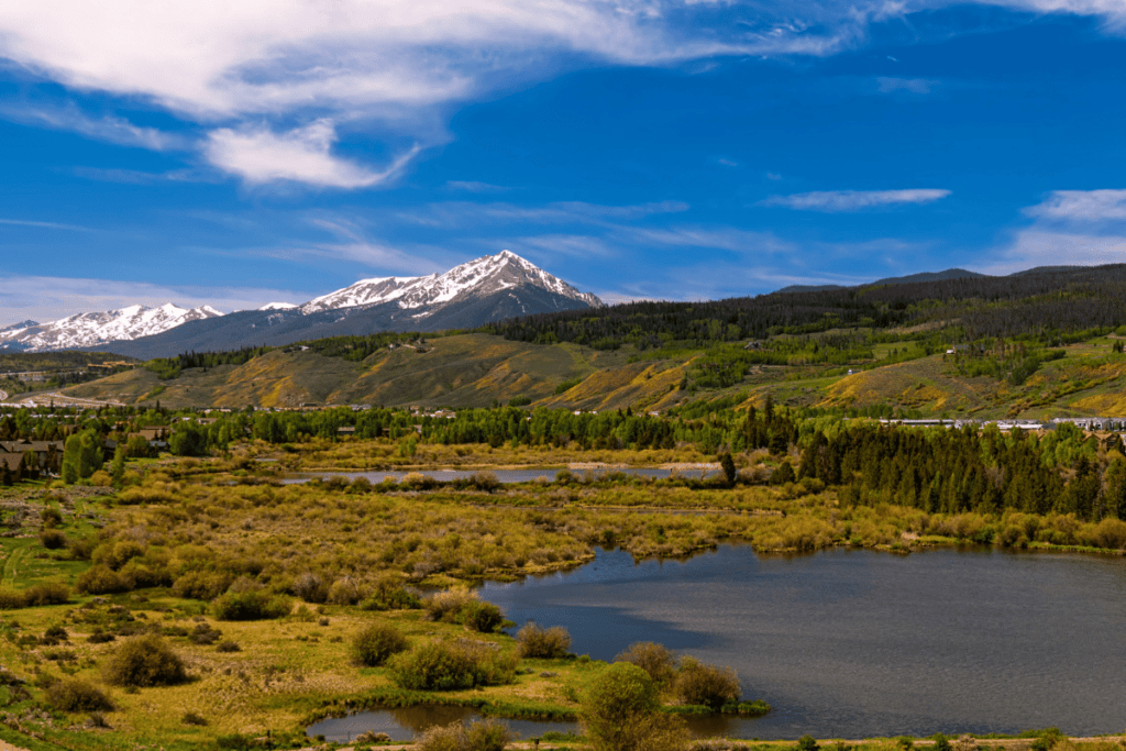 Silverthorne, Colorado in the Fall with blue skies and mountains in the background. 